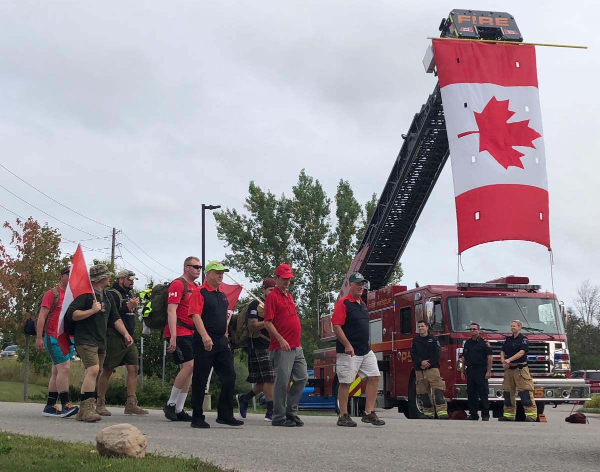 Members of Ruck 2 Remember stop in Guelph during their annual 150-kilometre Road 2 Recovery event on Friday afternoon.