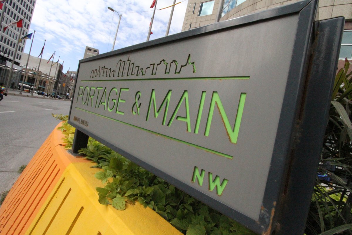 A sign marks the corner of Portage Avenue and Main Street in Winnipeg.