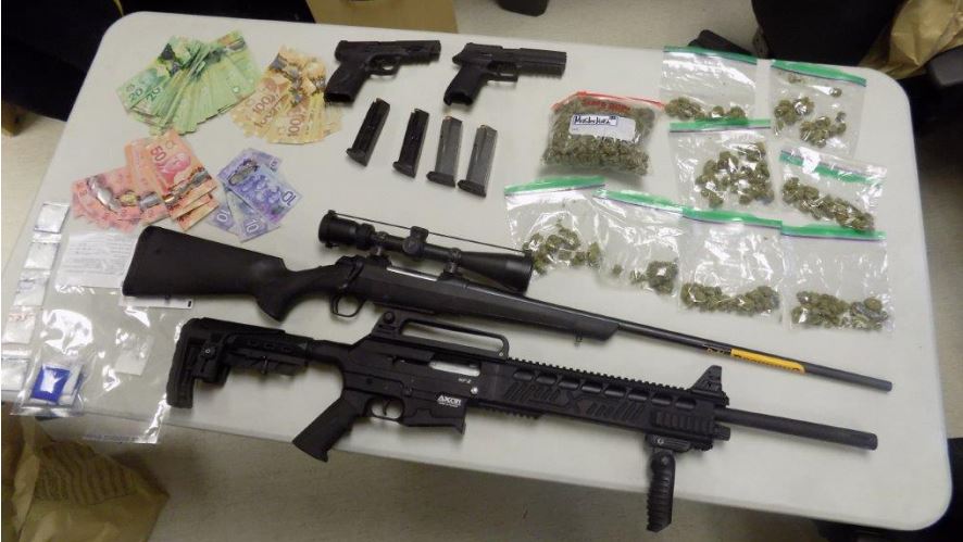 Police found drugs, guns, and cash during a raid in Peguis First Nation Friday.