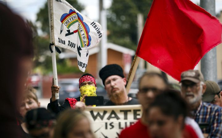 This June 12, 2019 file photo shows demonstrators against the Keystone XL pipeline walking to to Andrew W. Bogue Federal Courthouse in in Rapid City, S.D. 