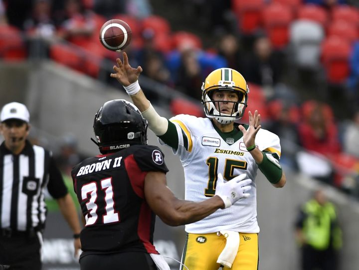 Edmonton Eskimos quarterback Logan Kilgore (15) throws the ball as Ottawa Redblacks linebacker Kevin Brown II (31) defends, during first half CFL football action in Ottawa on Saturday, Sept. 28, 2019. 