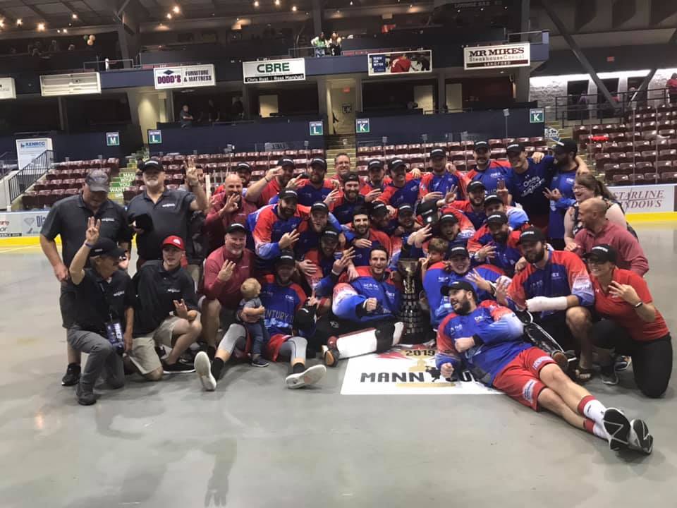 The Peterbourough Lakers celebrate their third-straight Mann Cup victory.