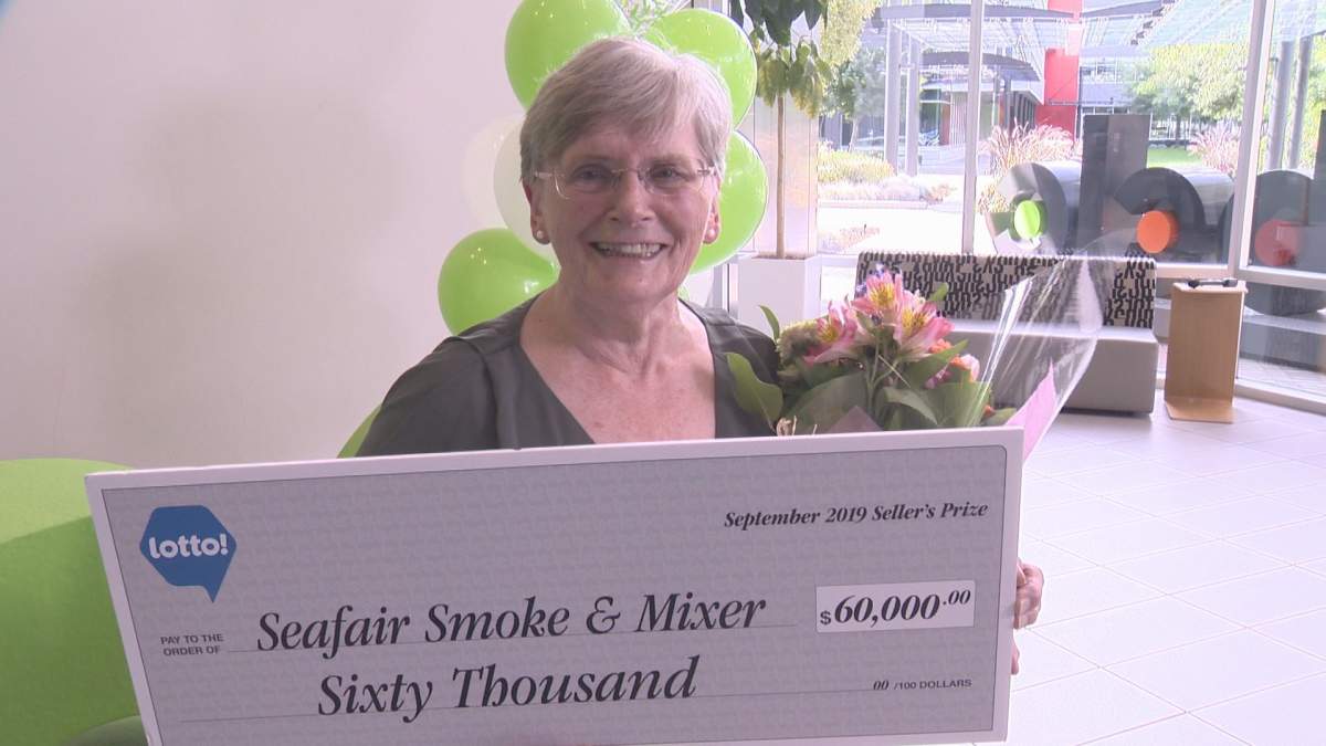 Verna Holmes celebrates her prize for selling the winning ticket in August's $60 million lotto jackpot. 