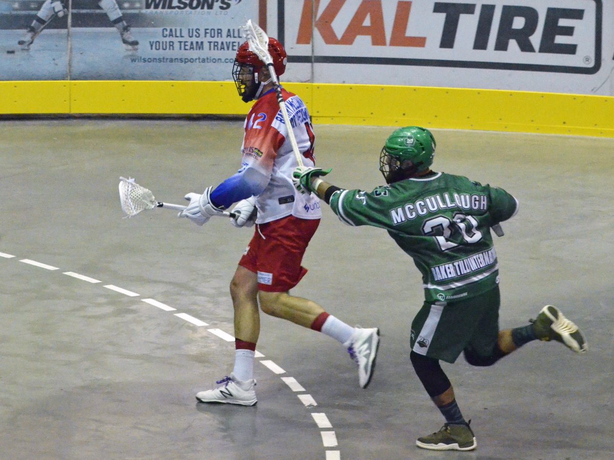 Peterborough Laker Mark Matthews, left,  outruns Victoria Shamrock Ben McCullough during Game 4 of the Mann Cup lacrosse championship in Colwood, B.C., on Tuesday.