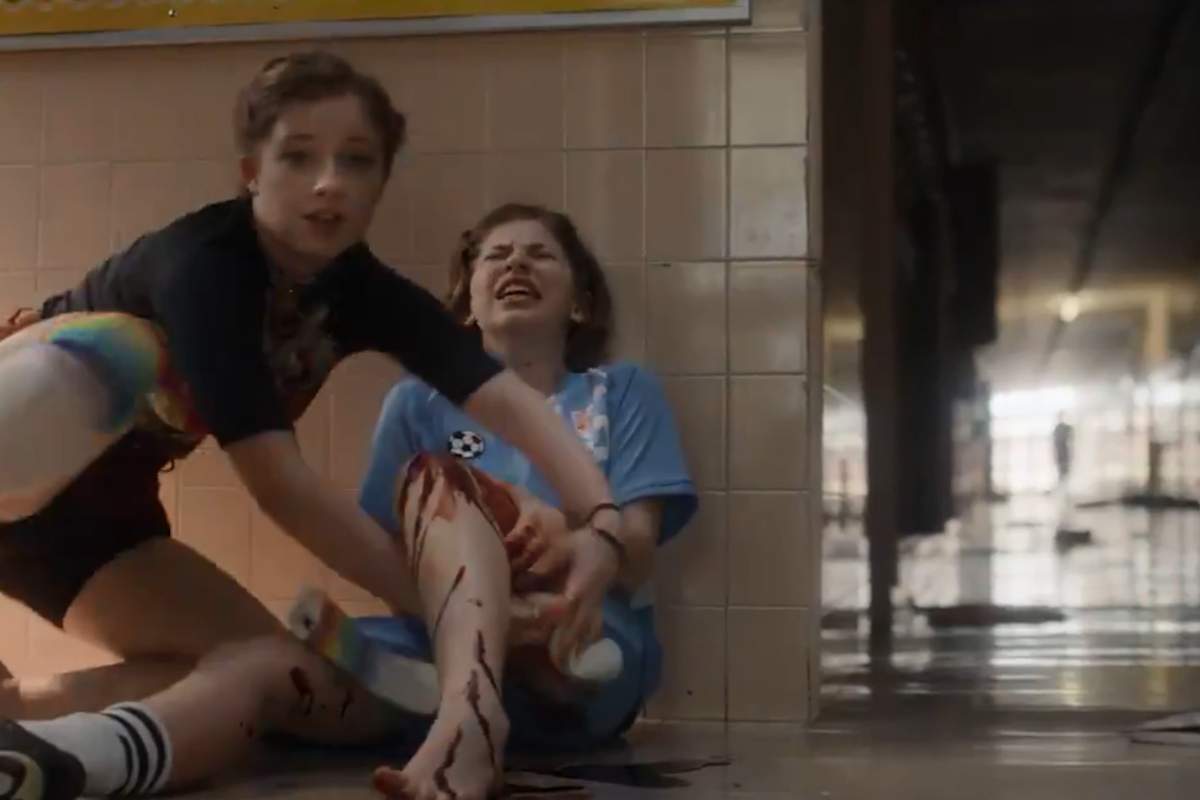A student uses a sock to help a wounded classmate during a mass shooting in this image from a PSA video.