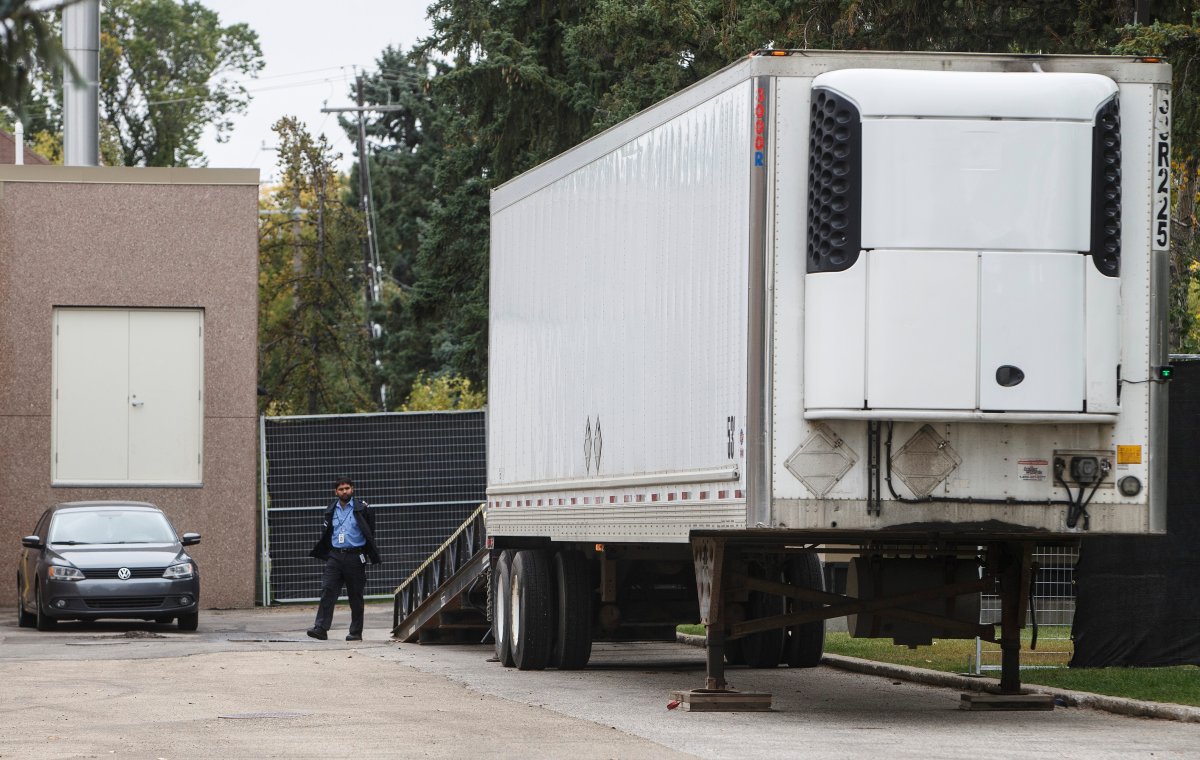 A security guard keeps an eye on a trailer where where bodies were reportedly stored in rented trailer as medical examiner copes with space shortage in Edmonton Alta, on Wednesday September 11, 2019. 