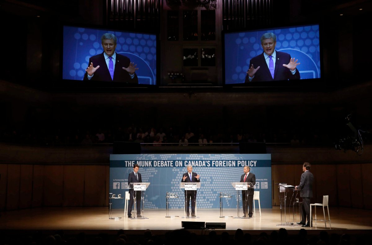Liberal Leader Justin Trudeau, left to right, Conservative Leader and Prime Minister Stephen Harper and New Democratic Party Leader Thomas Mulcair participate in the Munk Debate on Canada's foreign policy in Toronto, on September 28, 2015. Organizers of the same debate that was scheduled for Oct. 1, 2019, say they're cancelling the event because Trudeau won't participate.