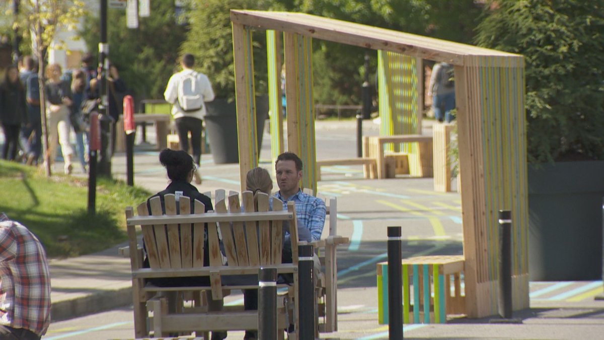 Pedestrians enjoy the new public space. 
