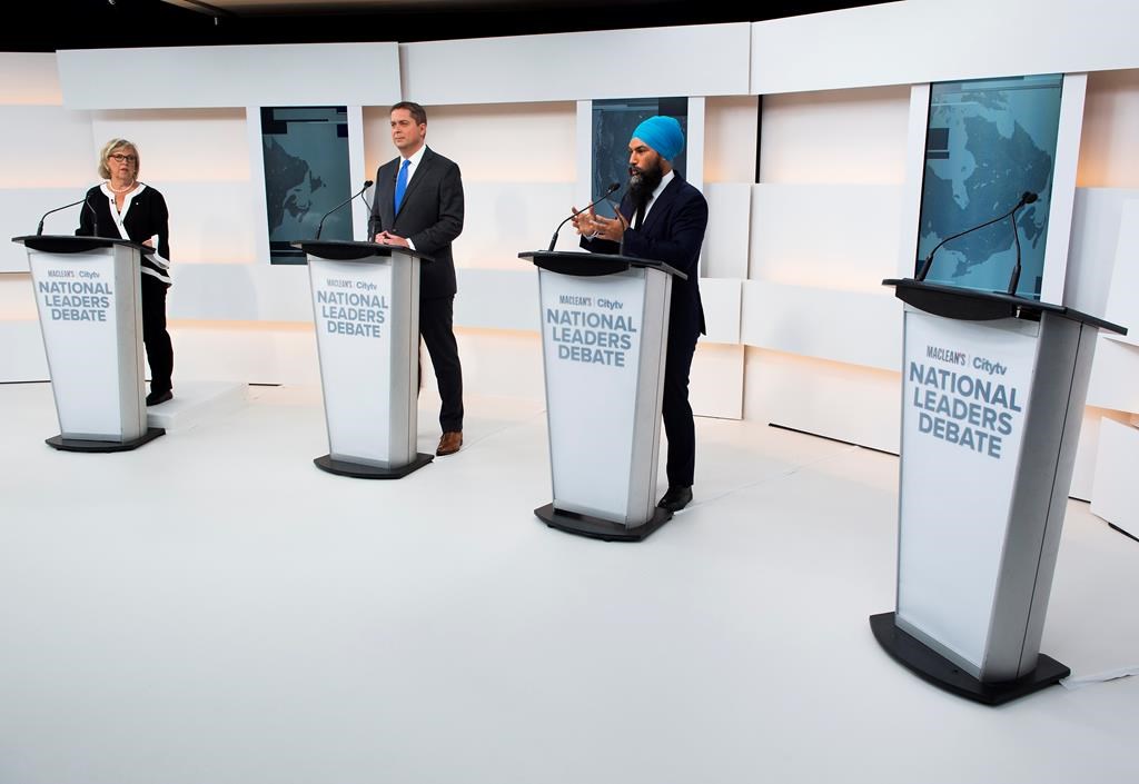 A empty podium stand where Liberal Leader Justin Trudeau turned down the invitation for the debate as Green Party Leader Elizabeth May, left, Conservative Leader Andrew Scheer, centre, and NDP Leader Jagmeet Singh take part during the Maclean's/Citytv National Leaders Debate in Toronto on Thursday, September 12, 2019.