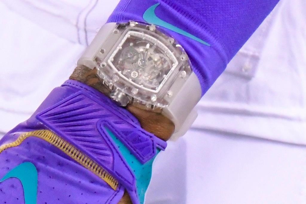 FILE - In this Sept. 16, 2019, file photo, Cleveland Browns' Odell Beckham wears a Richard Mille watch during warm ups before an NFL football game against the New York Jets, in East Rutherford, N.J. Football fashion plate Odell Beckham Jr. has switched watches. The Browns polarizing wide receiver has partnered with Swedish watchmaker Daniel Wellington, which introduced him Wednesday, Sept. 18, 2019, as “one of our new icons.” Beckham caused a minor uproar last week by wearing a nearly $200,000 Richard Mille watch during Cleveland’s home opener. (AP Photo/Bill Kostroun, File).