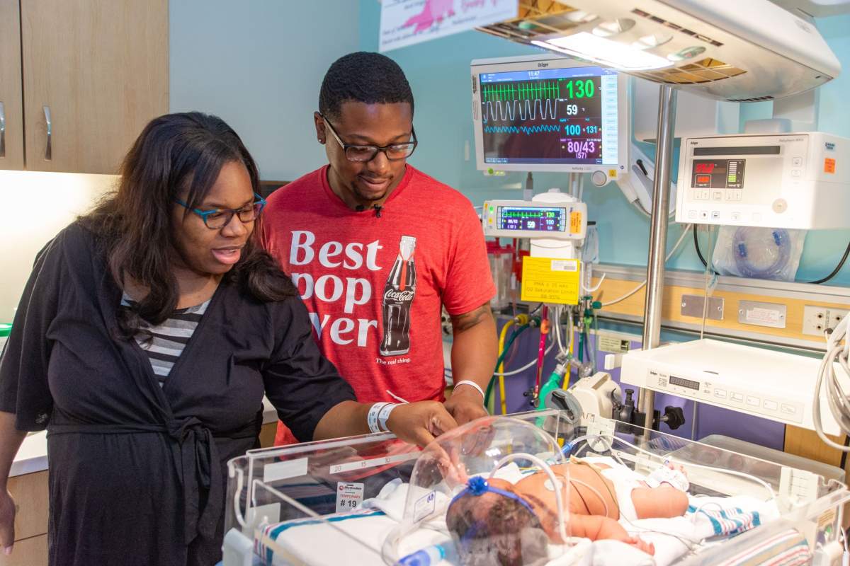 Cametrione Malone-Brown, left, and Justin Brown look at their daughter, Christina, who was born on Sept. 11, 2019.