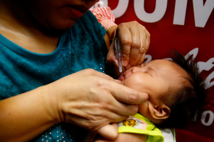 A baby gets an oral anti-polio vaccine during the launch of a campaign to end the resurgence of polio Friday, Sept. 20, 2019 at suburban Quezon city, northeast of Manila, Philippines. Philippine health officials declared a polio outbreak in the country on Thursday, nearly two decades after the World Health Organization declared it to be free of the highly contagious and potentially deadly disease.