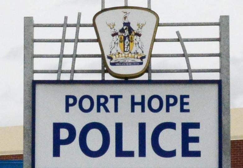 A woman is accused of biting and kicking Port Hope police officers during an arrest.