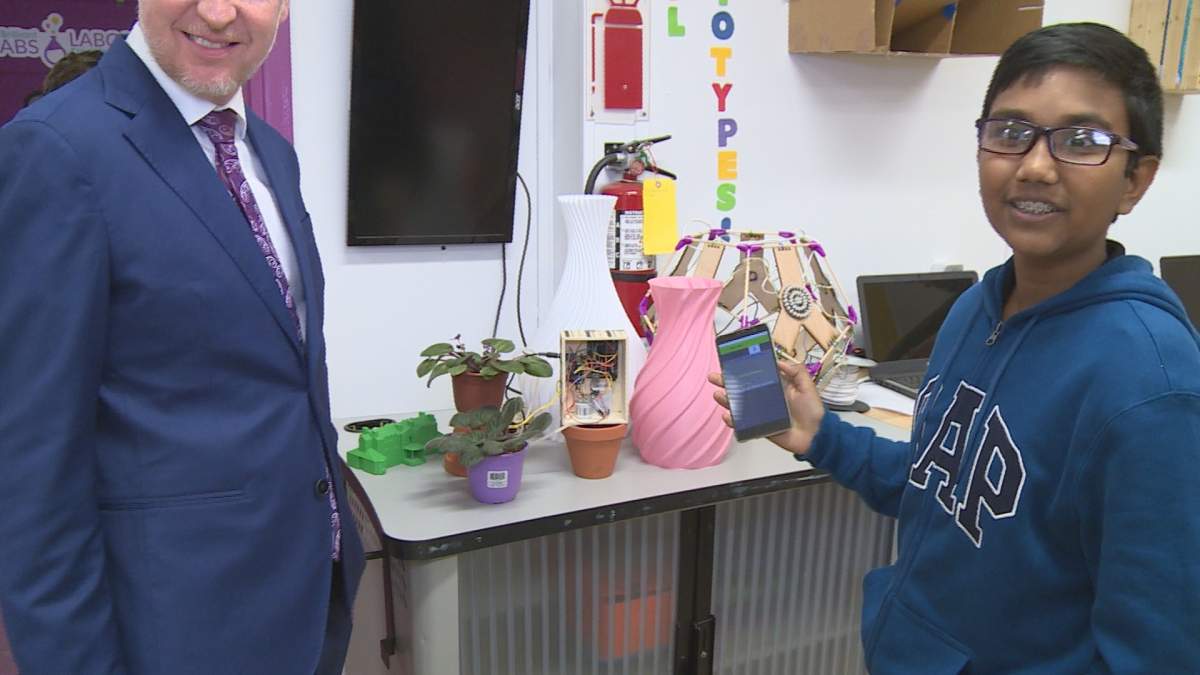 Rohan Katreddy a George Street Middle School student shows Dominic Cardy his app Flora Feed.