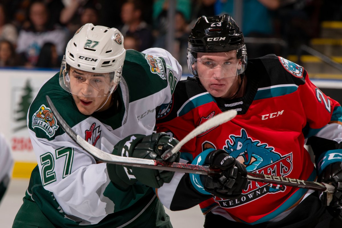 Forward Jalen Price of the Everett Silvertips checks forward Jake Poole of the Kelowna Rockets during first period at Prospera Place on September 28, 2019 .