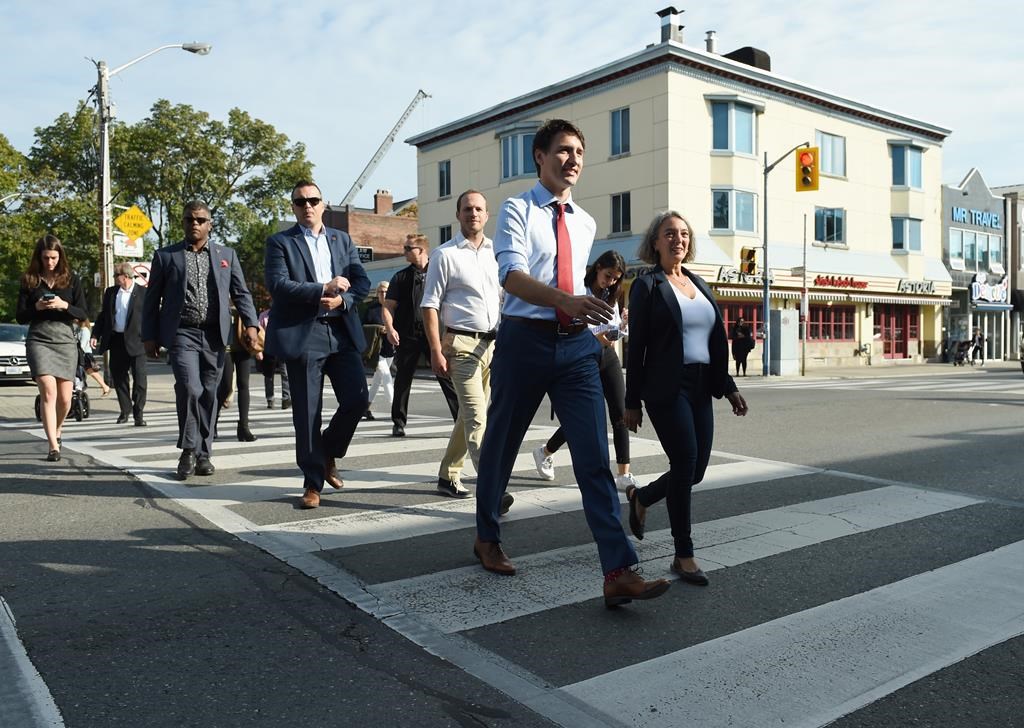 Liberal Leader Justin Trudeau crosses a street as he prepares to make a policy announcement in Toronto on Friday, Sept. 20, 2019.