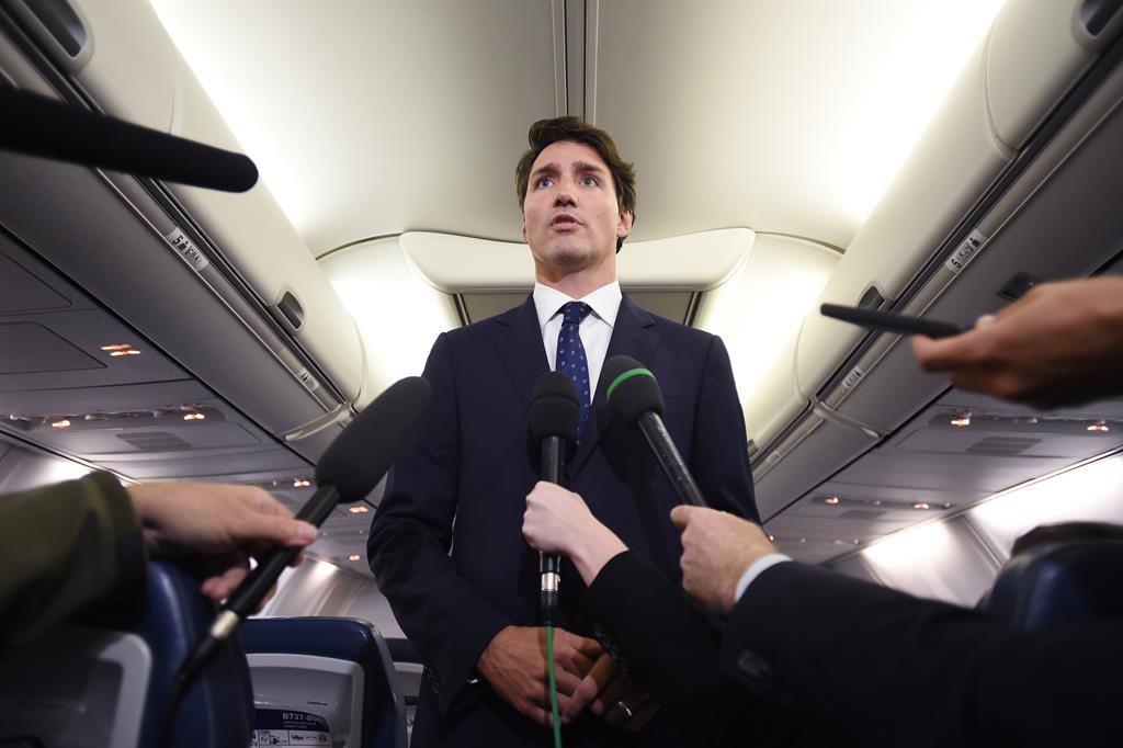 Liberal Leader Justin Trudeau makes a statement in regards to photo coming to light of himself from 2001 wearing "brownface" during a scrum on his campaign plane in Halifax, N.S., on Wednesday, September 18, 2019.