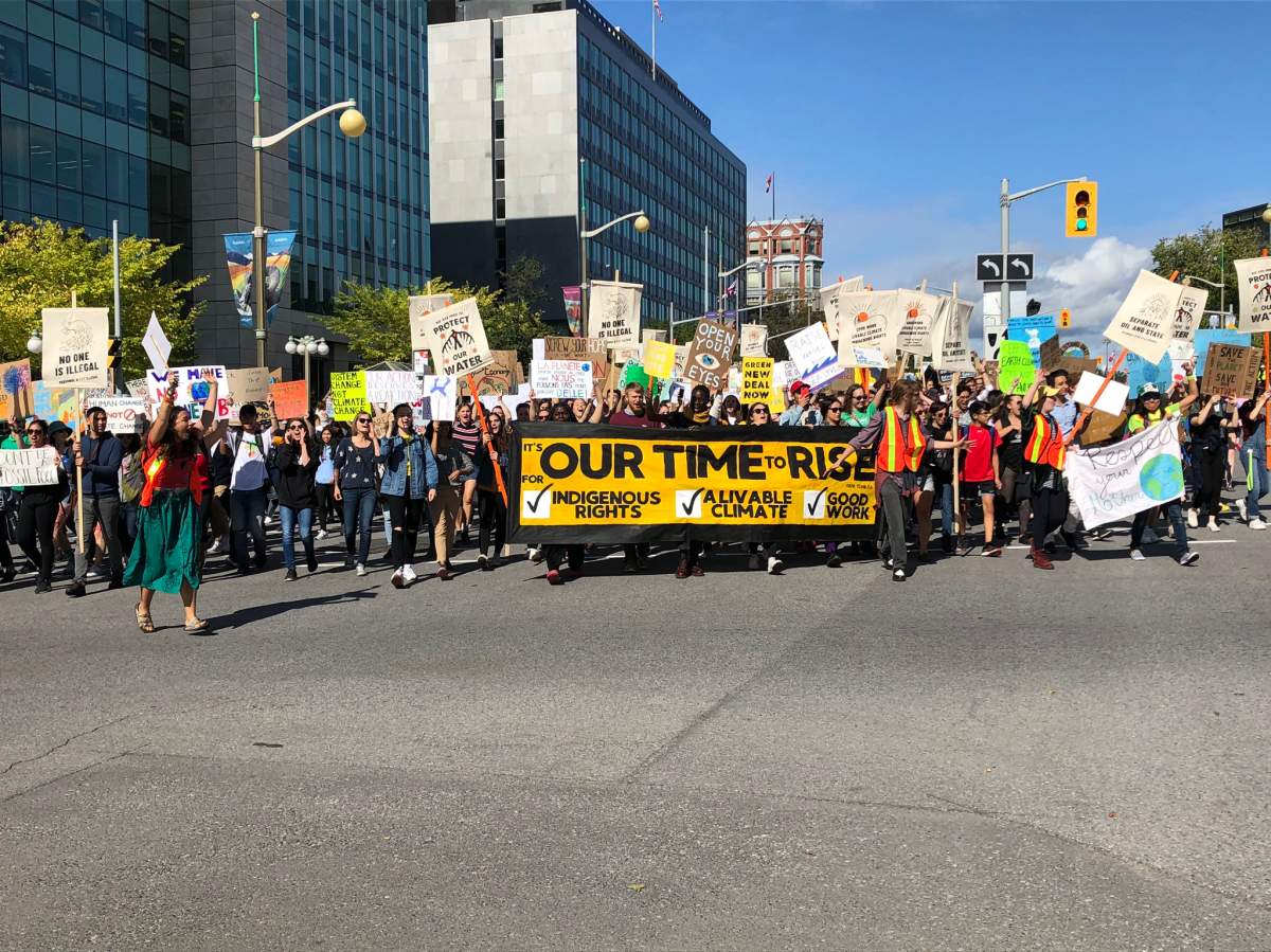 Global Climate strikers make their way down Elgin Street in Ottawa on their way to Parliament Hill on Friday.