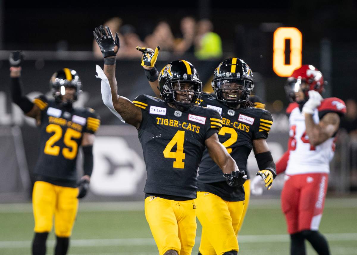 Hamilton Tiger Cats defensive back Richard Leonard (4) and teammate Tunde Adeleke (2) celebrate Hamilton's victory over the Calgary Stampeders in Hamilton, Ont., on Saturday, July 13, 2019.