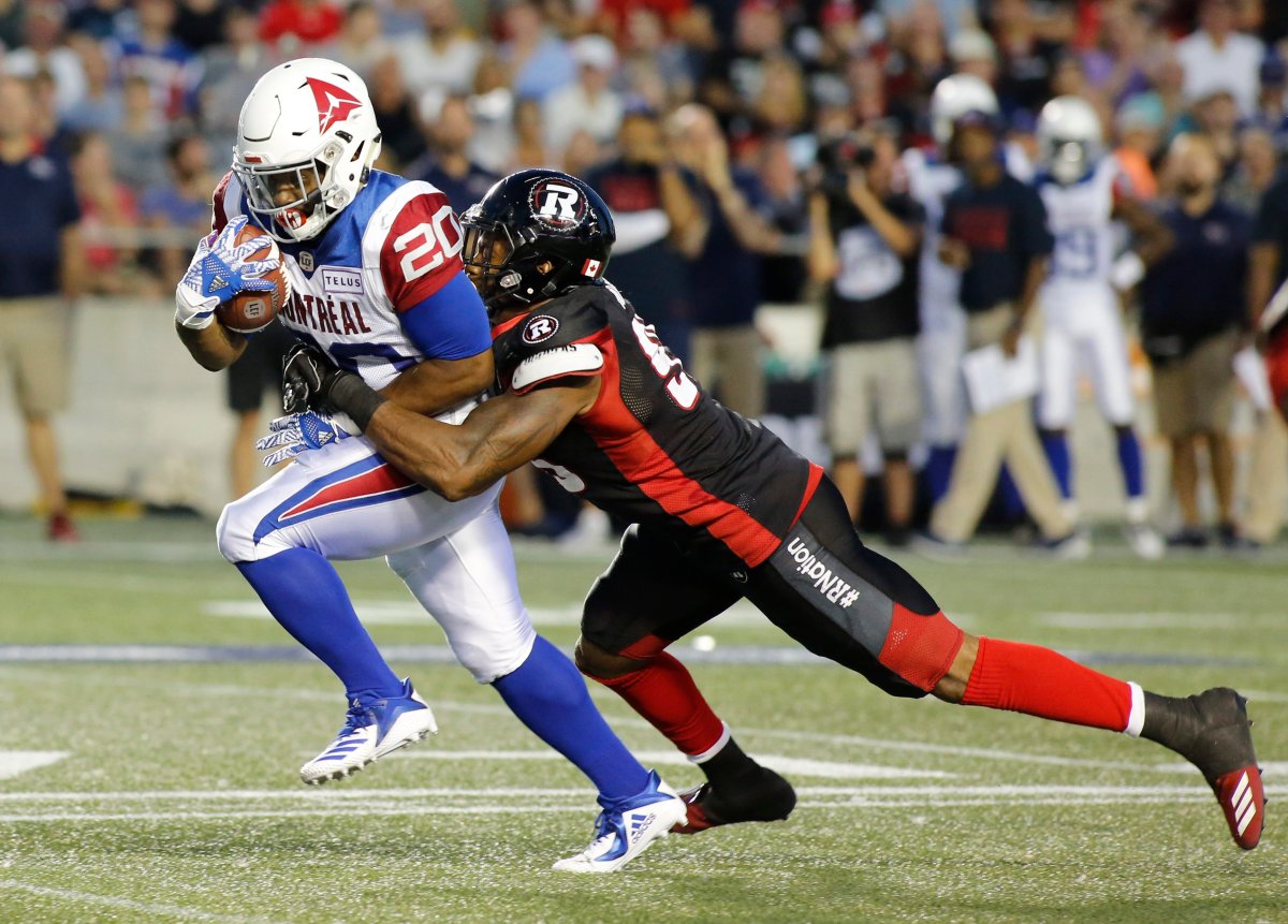 The Montreal Alouettes' Tyrell Sutton (20) is tackled by the Ottawa Redblacks' Danny Mason (95) during first-quarter CFL action in Ottawa on Saturday, Aug. 11, 2018.