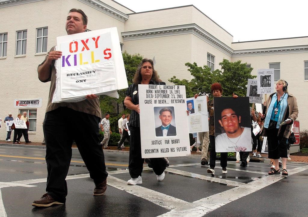In this July 20, 2007, file photo, Ed Bisch, left, and other demonstrators march along Main Street in Abingdon, Va., to raise awareness about the abuse of OxyContin. (David Crigger/Bristol Herald Courier via AP, File)