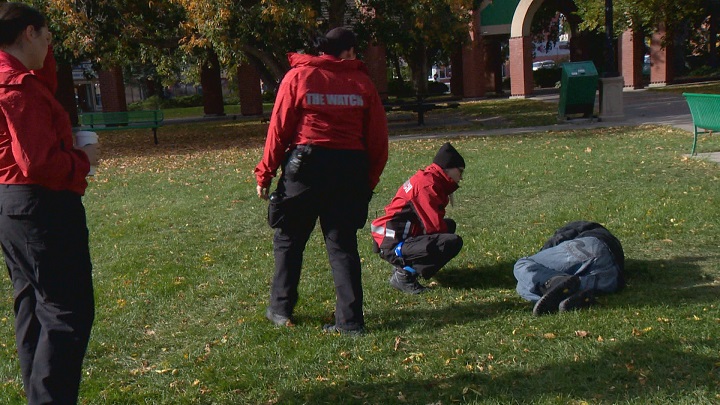 Team members from The Watch check on a sleeping man in Galt Gardens.