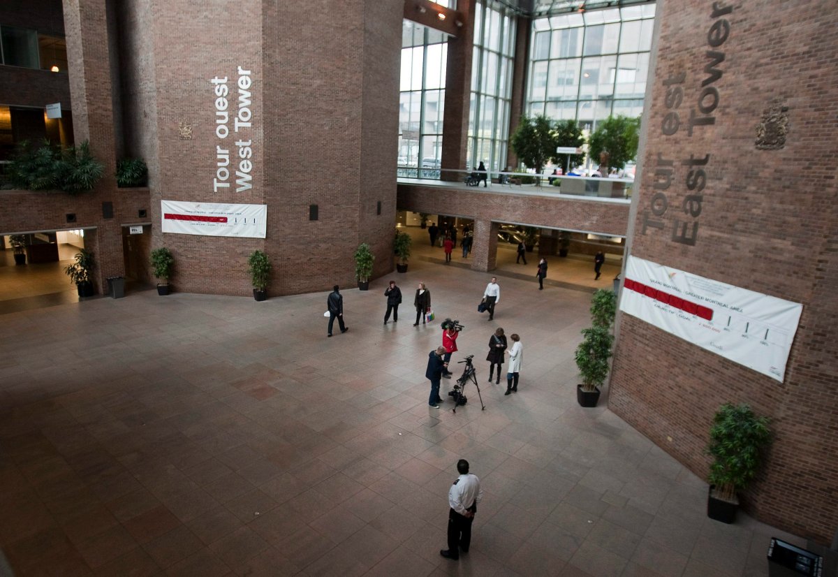 People walk through the barren atrium of Complexe Guy-Favreau on Friday, Dec. 2, 2011  in Montreal.