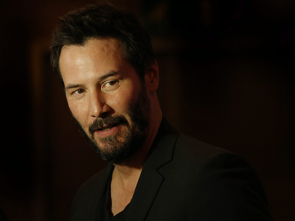 Keanu Reeves poses for photographers upon his arrival at the screening of the film John Wick in a central London hotel, on Wednesday March 25, 2015. 