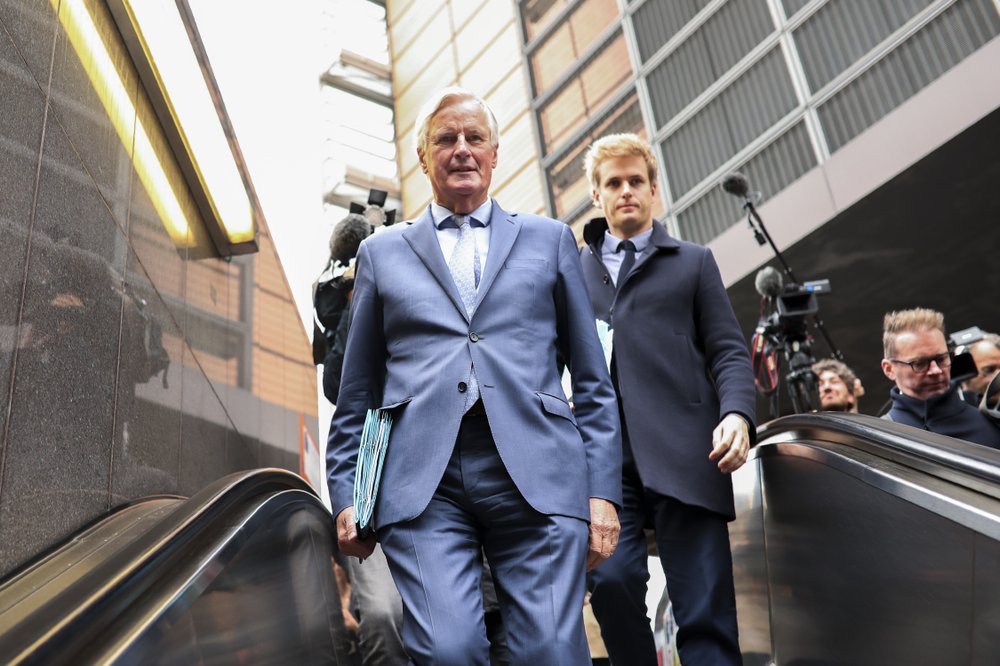 European Union chief Brexit negotiator Michel Barnier, left, rides an escalator on his way to a meeting at the Europa building in Brussels, Friday, Oct. 11, 2019. EU negotiator Michel Barnier says that he had a "constructive meeting" with British Brexit envoy Stephen Barclay and underscored the cautious optimism since Thursday's meeting between British Prime Minister Boris Johnson and his Irish counterpart Leo Varadkar. 