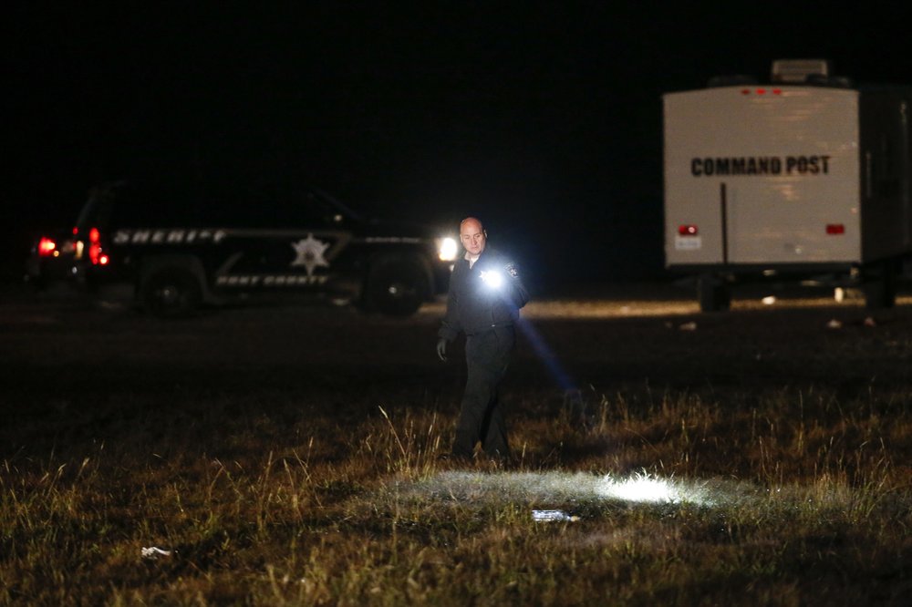 Authorities work the scene after a deadly shooting in Greenville, Texas, on Sunday, Oct. 27, 2019. A gunman opened fire at an off-campus Texas A&M University-Commerce party, which left over a dozen injured before he escaped in the ensuing chaos, a sheriff said Sunday. 
