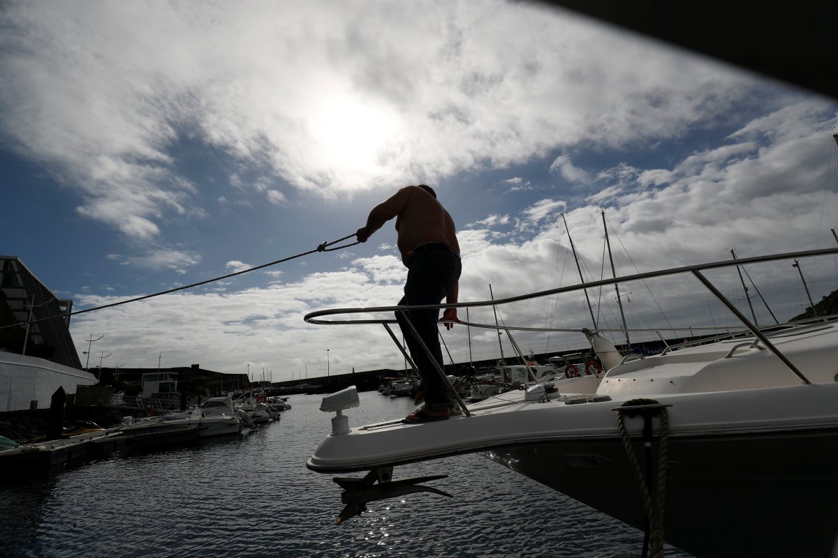 A man reinforces with ropes the mooring of his boat at a port before the arrival of Hurricane Lorenzo in Angra do Heroismo in the Azores islands, Portugal October 1, 2019. 