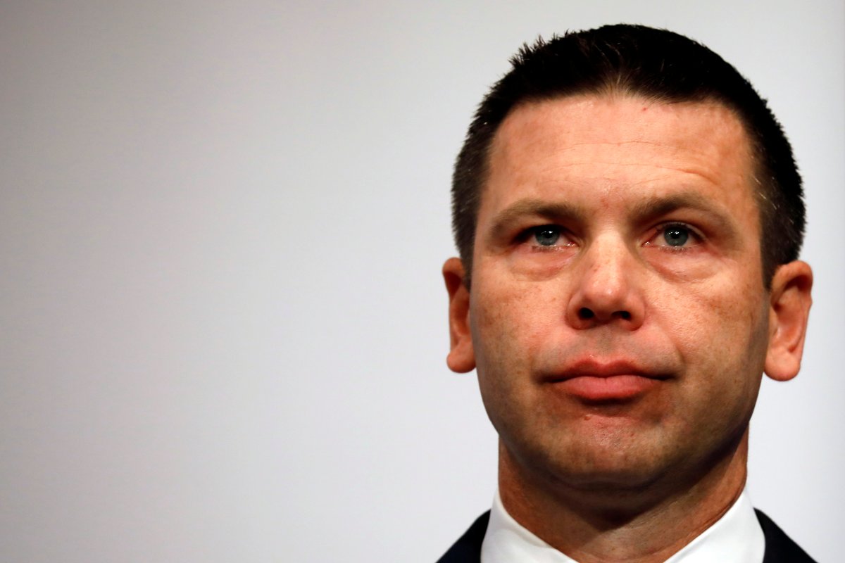 Acting Department of Homeland Security (DHS) Secretary Kevin McAleenan reacts while protesters interrupt his remarks at the Migration Policy Institute annual Immigration Law and Policy Conference in Washington, U.S., October 7, 2019. 