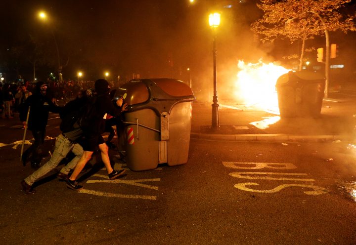 Demonstrators push the trash bin during protest after a verdict in a trial over a banned Catalonia’s independence referendum, near Catalan Interior Ministry in Barcelona, Spain, October 16, 2019.