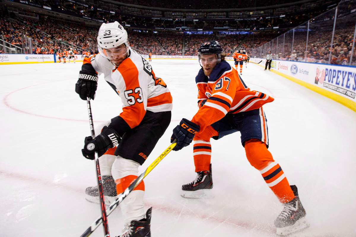 Philadelphia Flyers' Shayne Gostisbehere (53) and Edmonton Oilers' Connor McDavid (97) battle for the puck during second period NHL action in Edmonton, Alta., on Friday December 14, 2018. THE CANADIAN PRESS/Jason Franson.