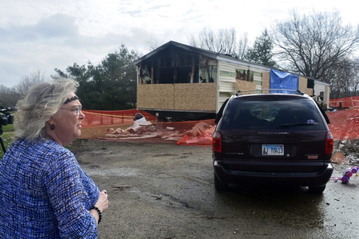 In this Sunday, April 7, 2019 photo, Marie Chockley, a resident of the Timberline Trailer Court, north of Goodfield, Ill., surveys the damage that was caused by a Saturday night fire that killed five residents in a mobile home. 