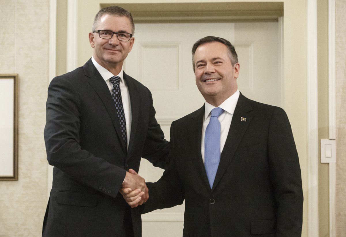 Alberta premier Jason Kenney shackles hands with Travis Toews, President of Treasury Board and Minister of Finance after being sworn into office,in Edmonton on Tuesday April 30, 2019. 