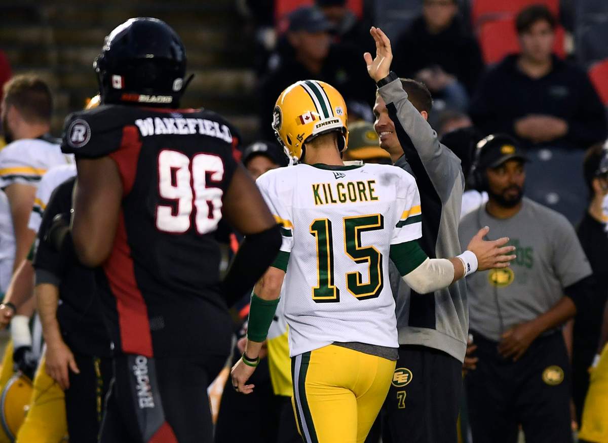 Edmonton Eskimos quarterback Logan Kilgore (15) gets congratulated by Edmonton Eskimos quarterback Trevor Harris, who was not playing in the game, during second half CFL football action against the Ottawa Redblacks in Ottawa on Saturday, Sept. 28, 2019.