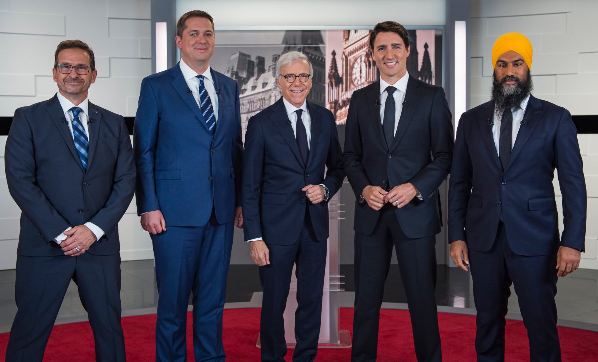 Left to right: Bloc Québécois Leader Yves-François Blanchet, Conservative Leader Andrew Scheer, TVA host Pierre Bruneau, Liberal Leader Justin Trudeau and NDP Leader Jagmeet Singh pose for a photo at the TVA French debate for the 2019 federal election in Montreal, Wednesday, Oct. 2, 2019.