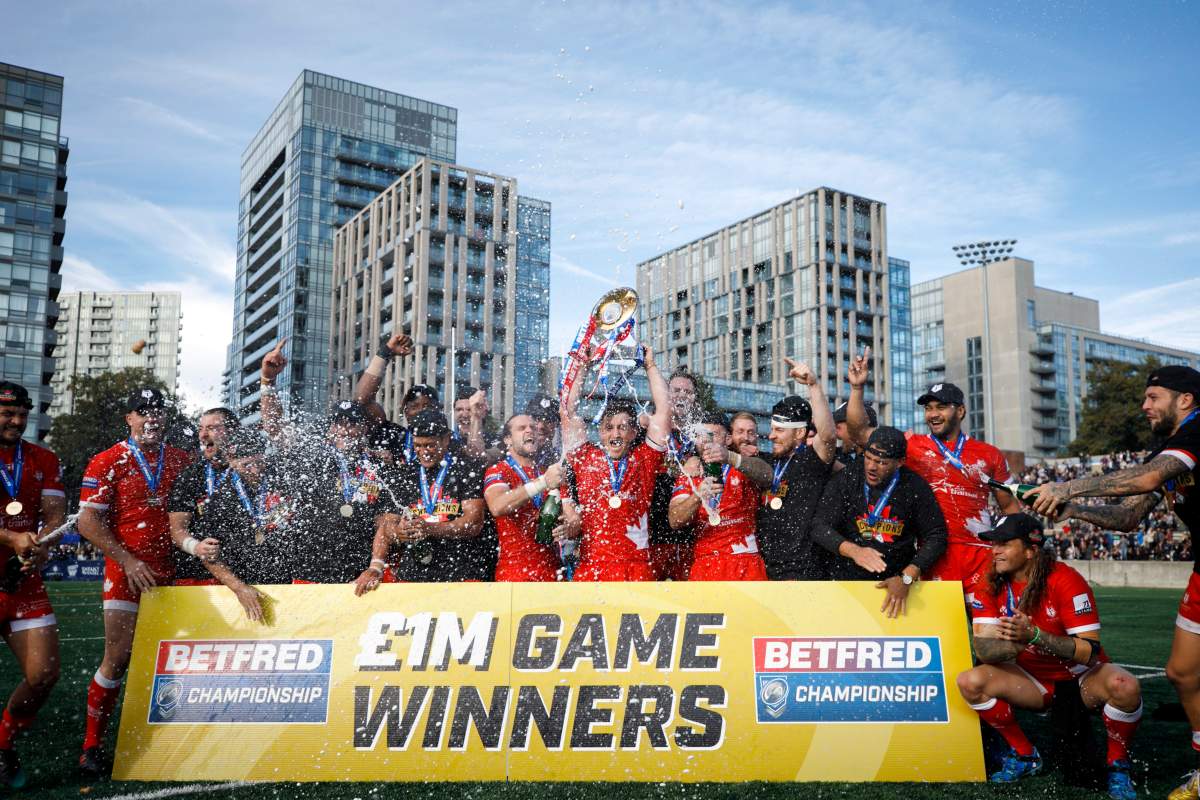 Toronto Wolfpack captain Josh McCrone raises the Betfred Championship Trophy alongside teammates after defeating the Featherstone Rovers in the Million Pound Game in Betfred Championship rugby league action in Toronto, Saturday, Oct. 5, 2019.