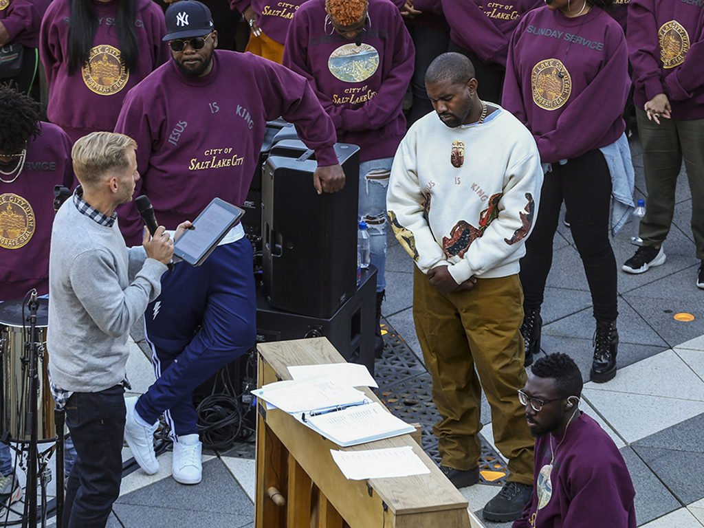 Kanye West (R) bows his head in prayer during his Sunday Service at The Gateway in Salt Lake City, Utah, on Saturday, Oct. 5, 2019.