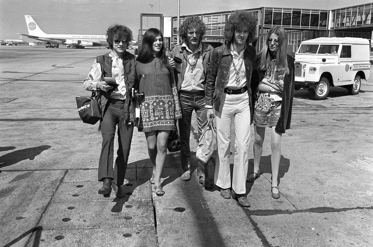 In this Aug. 20, 1967 file photo, members of the rock group Cream depart from Heathrow Airport in London, for their American tour. The trio, walking with unidentified female companions, from left are, base guitarist Jack Bruce, drummer Ginger Baker, and lead guitarist Eric Clapton. Baker, the volatile and propulsive British musician who was best known for his time with the power trio Cream, died Sunday, Oct. 6, 2019, at age 80, his family said.
