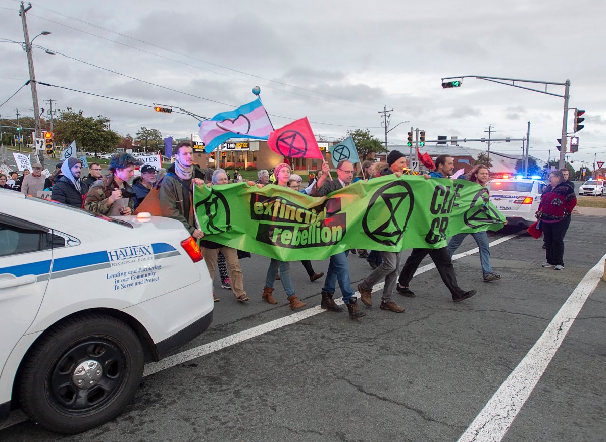 Members of Extinction Rebellion, protesting issues related to climate change, march to the Angus L. Macdonald Bridge in Dartmouth, N.S. on Oct. 7, 2019.