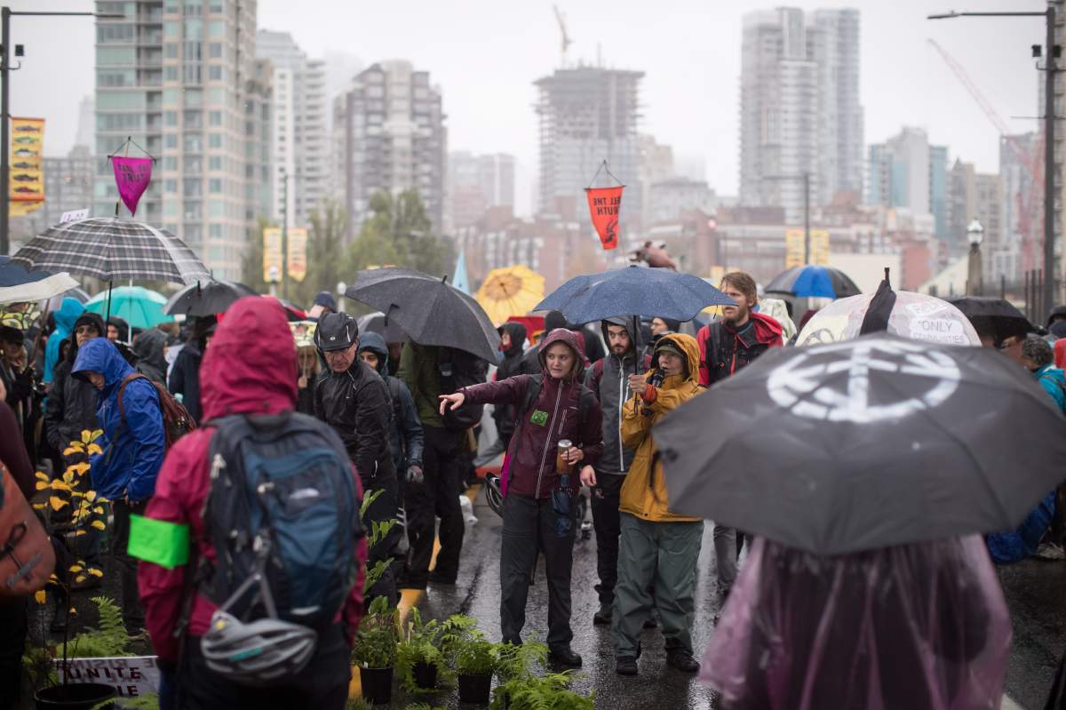 Protesters with the group Extinction Rebellion occupy the Burrard Bridge, closing it to vehicle traffic going into and out of downtown Vancouver, on Monday October 7, 2019.
