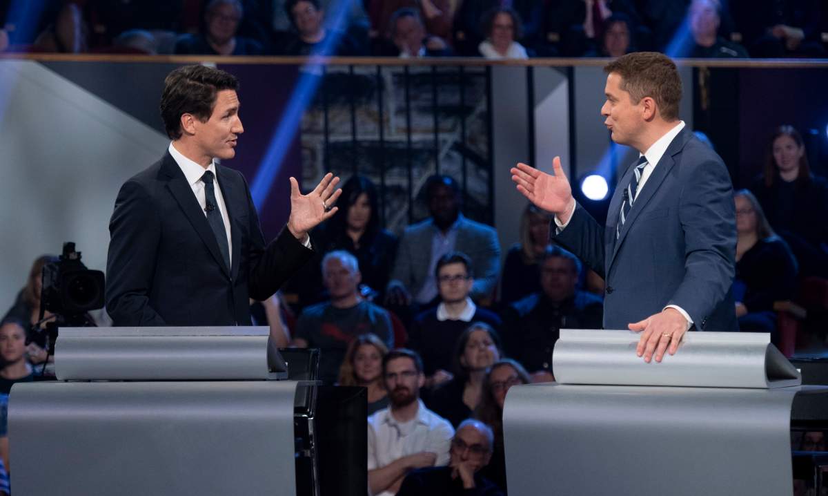 Conservative leader Andrew Scheer, right, and Liberal leader Justin Trudeau gesture to each other as they both respond during the Federal leaders debate in Gatineau, Que. on Monday, October 7, 2019. THE CANADIAN PRESS/Justin Tang