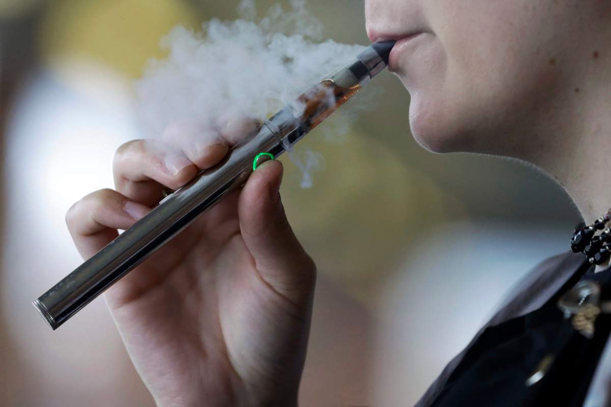 In this file photo, a woman uses an electronic cigarette.