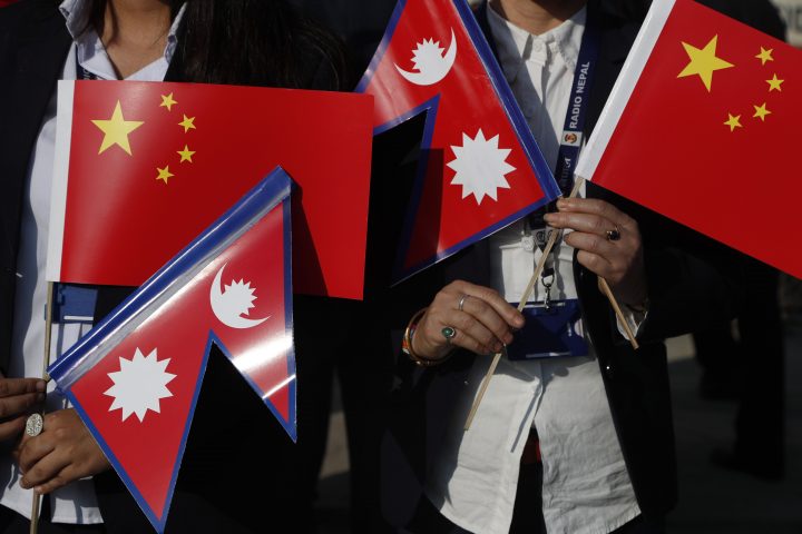 Government officers hold Chinese and Nepalese flag as they wait to welcome Chinese president Xi Jinping  in Kathmandu, Nepal, Saturday, Oct 12, 2019. Xi has become the first Chinese president in more than two decades to visit Nepal, where he's expected to sign agreements on major infrastructure projects.