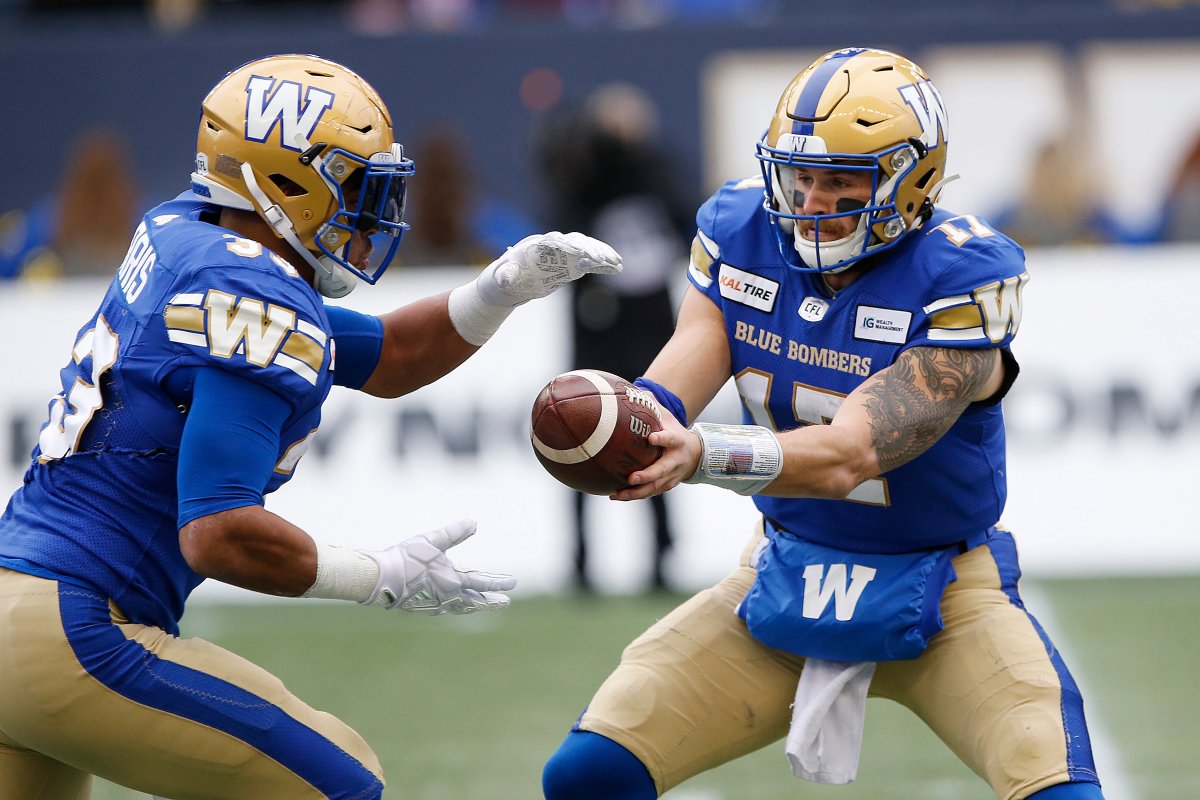 Winnipeg Blue Bombers quarterback Chris Streveler (17) hands off to Andrew Harris (33) during the first half of CFL action against the Montreal Alouettes, in Winnipeg, Saturday, Oct. 12, 2019.