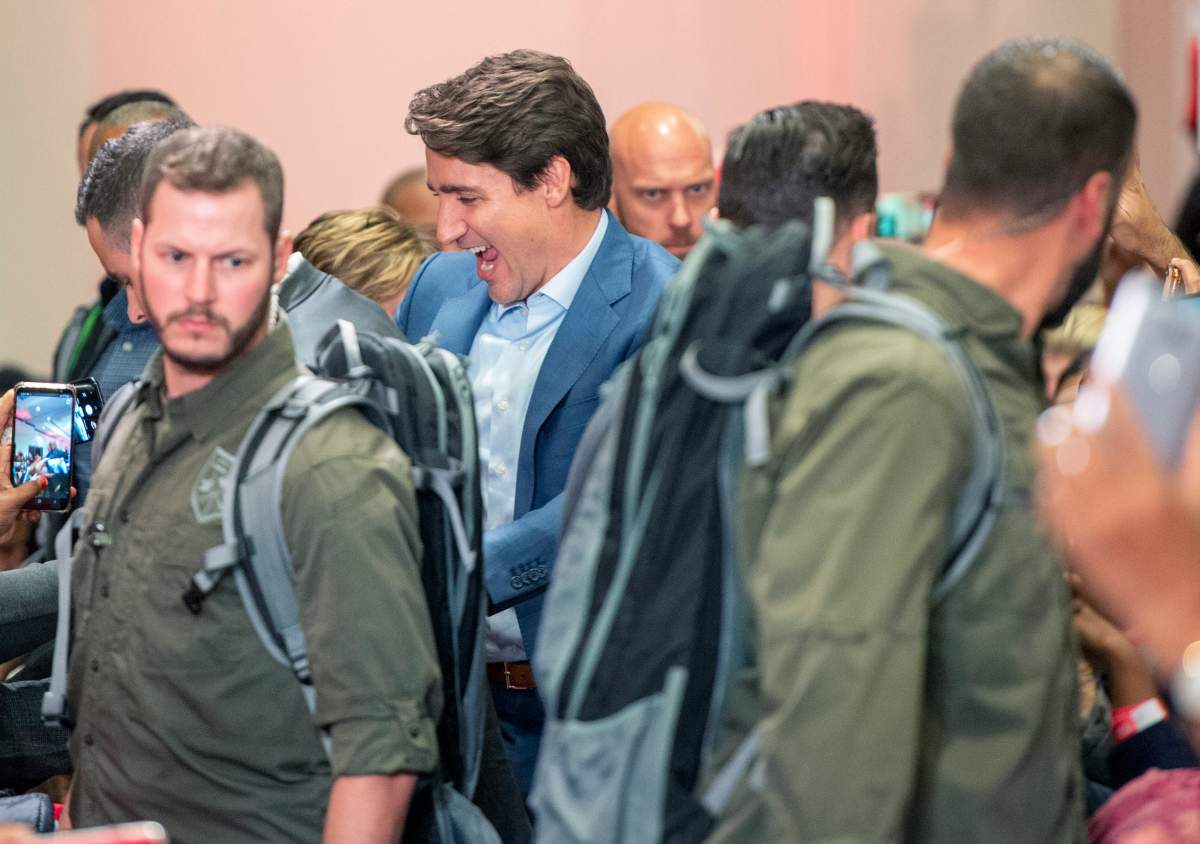 High profile security surrounds Liberal Leader Justin Trudeau as he arrives at a rally in Mississauga, Ont., Saturday, Oct. 12, 2019. The Rally was delayed for 90 minutes due to a security issue.