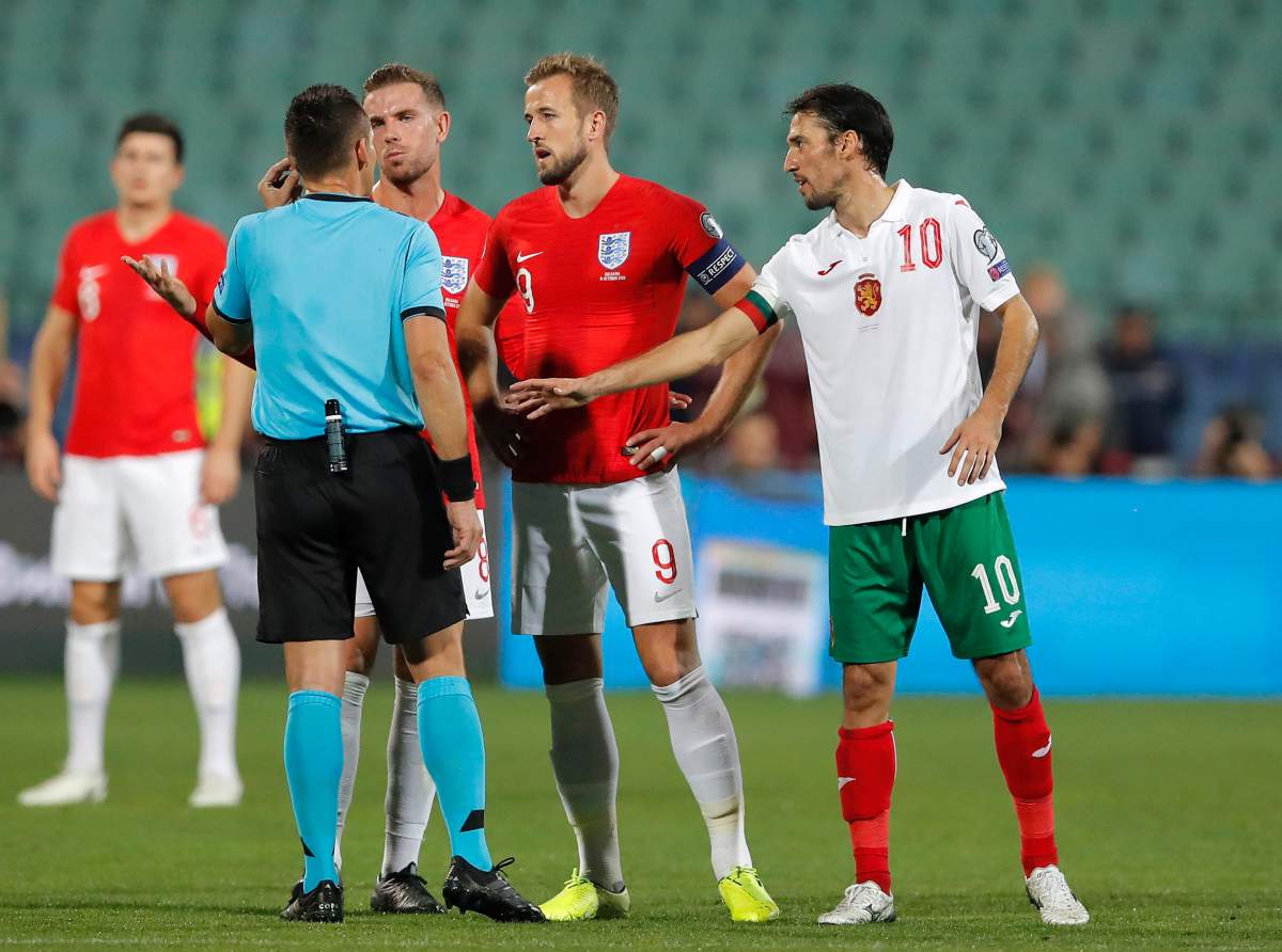 England's Harry Kane, center, and Jordan Henderson speak with Referee Ivan Bebek during the Euro 2020 group A qualifying soccer match between Bulgaria and England, at the Vasil Levski national stadium, in Sofia, Bulgaria, Monday, Oct. 14, 2019. 