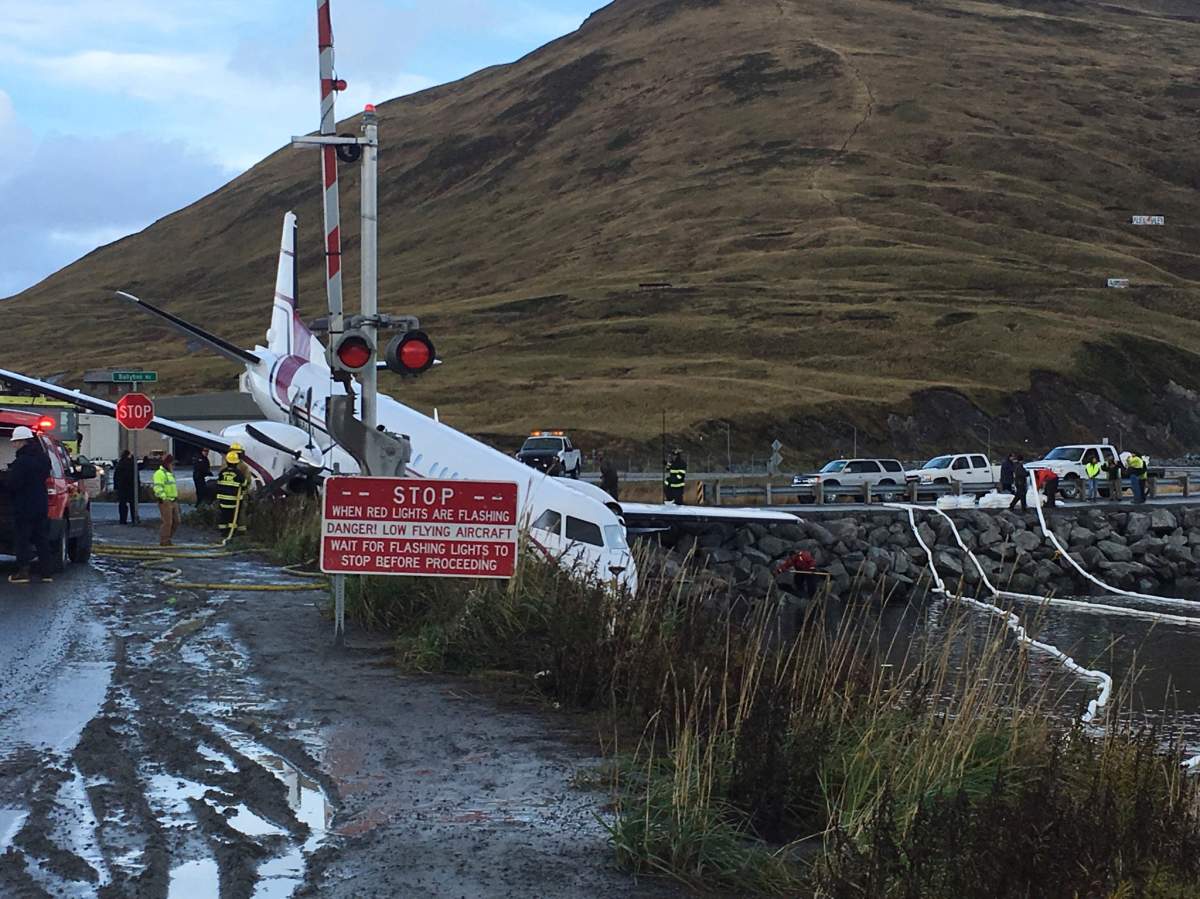 A commuter airplane has crashed near the airport in a small Alaska community on the Bering Sea, Thursday, Oct. 17, 2019, in Unalaska, Alaska. Freelance photographer Jim Paulin says the crash at the Unalaska airport occurred Thursday after 5 p.m. Paulin says the Peninsula Airways flight from Anchorage to Dutch Harbor landed about 500 feet (152 meters) beyond the airport near the water. 